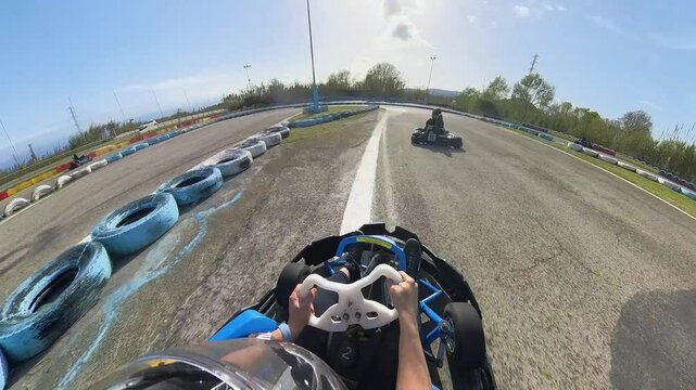 Fun race with tiny cars karting on a tarmac circuit helmet point of view with overtakes and crashes on a racing sports event