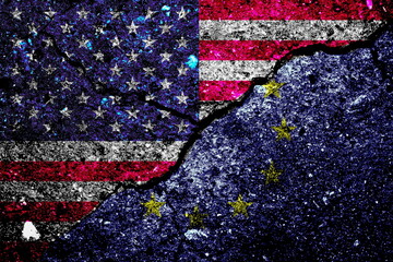 Rifts between US and EU flags on concrete due to tariffs and trade war