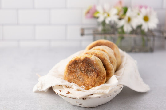 White Wooden Bowl of Homemade English Muffins