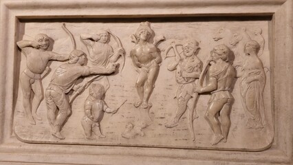 Marble relief of Saint Sebastian tied and shot with arrows, surrounded by archers and onlookers, capturing a dramatic biblical martyrdom scene.