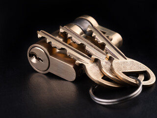 New door lock with keys used in households. Dark background.