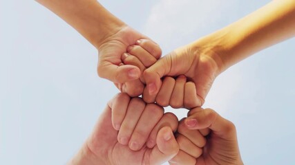 People hold hands together. Friends gather in a circle. Unity helps us grow. We can achieve more together. We place our hands together in unity. The gesture strengthens our connection. Each person
