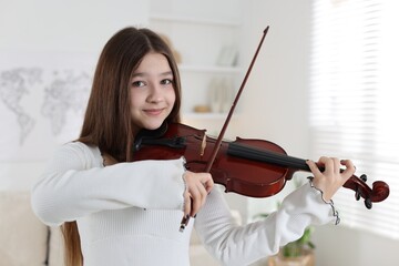 Teenage girl playing violin at music lesson © New Africa