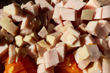 Diced salami for salad. Macro shot. Easy to prepare dish. Processed meat industry.