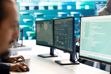 Governmental hacker investigating cyber incidents and monitoring security threats on a big screen....