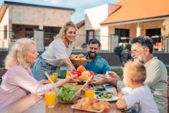Happy family enjoying lunch together in the backyard