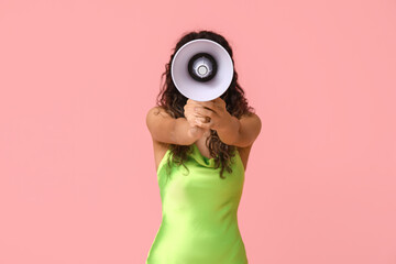 Fototapeta premium Young African-American woman with megaphone on pink background