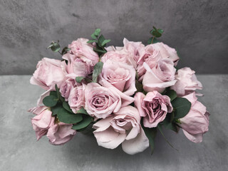 Delicate pink roses forming a bridal bouquet on a gray background wallpaper copy space