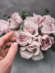 Florist arranging wedding bouquet with delicate pink roses wallpaper background copy space