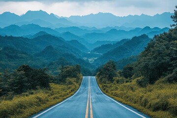 Fototapeta premium Winding road through misty mountains