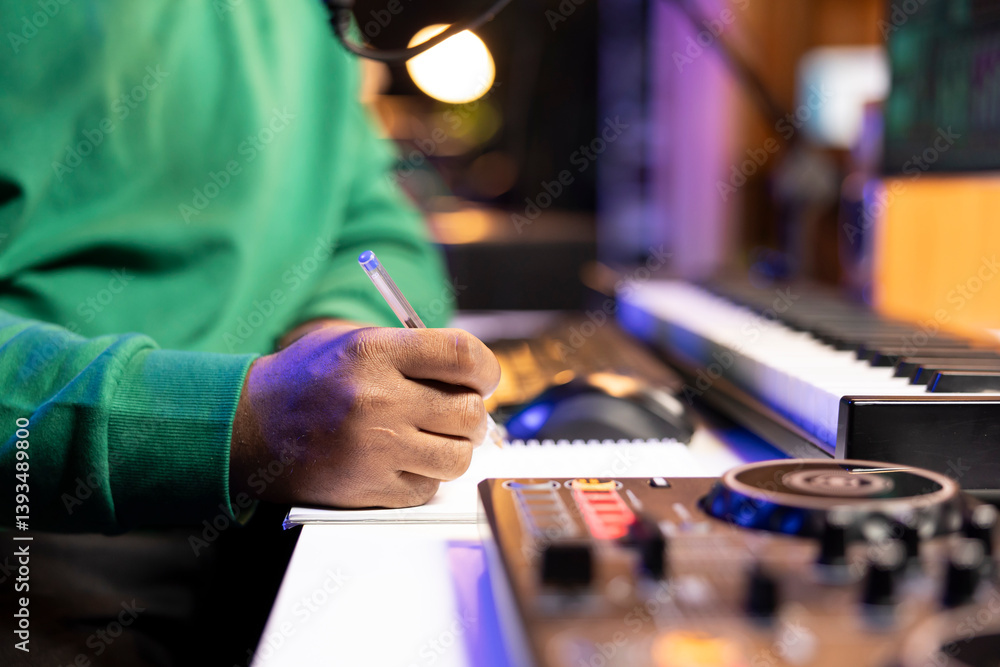 Aufkleber songwriter taking notes on paper to compose a new soundtrack, making rhymes and mixing musical eleme