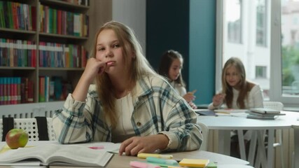 Boring school education sad frustrated bored kid Caucasian girl teenager pupil schoolgirl daughter child studying lesson in classroom difficult hard task reading book in library tired stressed student - Powered by Adobe