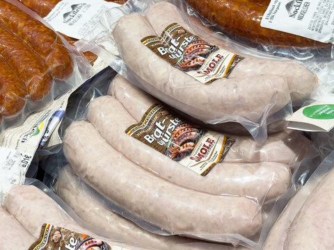 Assorted packaged sausages display with bratwurst and knackwurst varieties