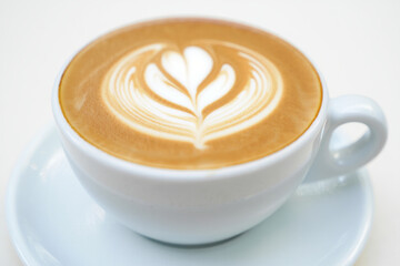 Cappuccino in White Cup with Foam Art on White Background