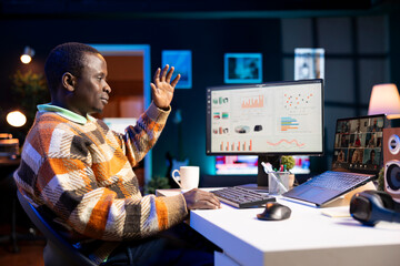 African American man having discussion during online meeting on laptop, talking about internet...