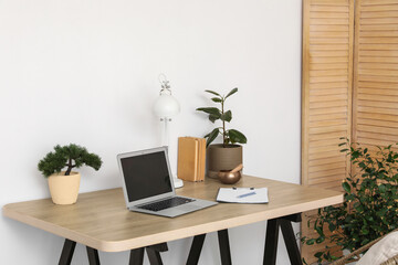 Workplace with laptop and Tibetan singing bowl in office
