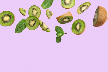 Fresh cut kiwi and mint leaves flying on lilac background