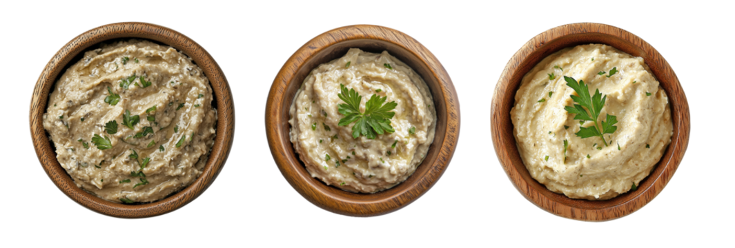 Top view of baba ghanoush in wooden bowls, garnished with parsley, isolated on transparent or white background, traditional Middle Eastern eggplant dip for Mediterranean meals