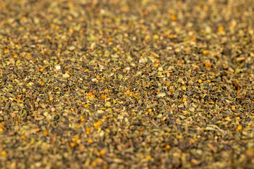 dried tea leaves, ground and crumbled into very small pieces , tea leaf powder , top view