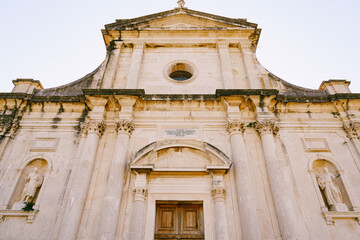 Fototapeta premium Facade of the Church of the Nativity of Virgin against the sky. Prcanj, Montenegro