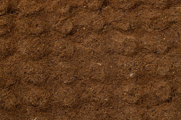 a part of an old mattress made from glued coconut chips, a part of a used coconut mattress