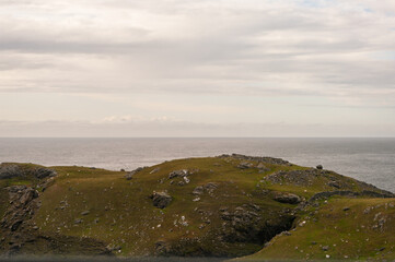 A rocky hillside overlooking the ocean