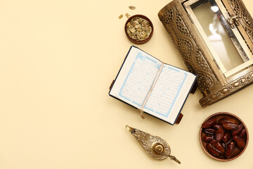 Koran, dates, Aladdin lamp and pumpkin seeds on yellow background. Ramadan celebration