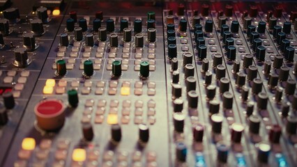 Pre amp knobs and switchers on mixing console panel board, audio stereo equipment used in music...