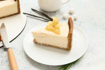 Plate of sweet cheesecake with vanilla flower and sticks on white background