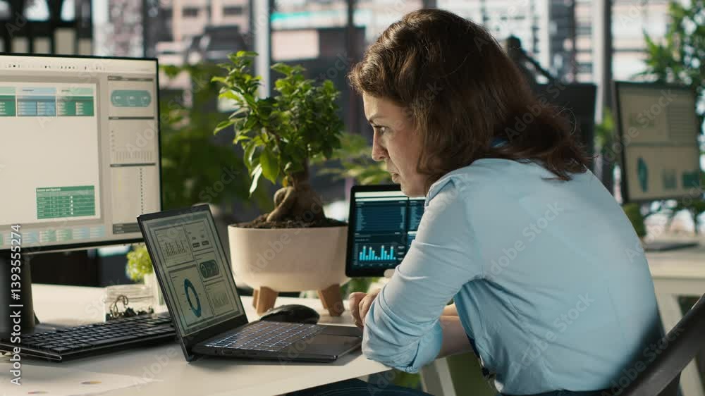 Poster employee at office desk getting upset after noticing mistake while editing documents, typing on keyb