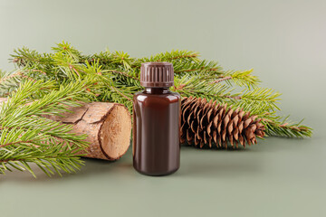 Essential coniferous tree oil with pine branches and cone
