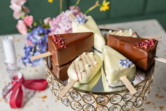 Cake pop sicles on an elegant stand with floral decor