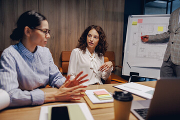 A business meeting highlighting teamwork, collaboration, and strategic discussions among...