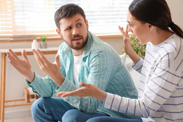 Young man quarreling with his wife at home
