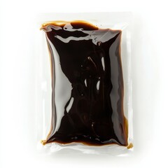 Sealed soy sauce sachet on white background - transparent packet with dark liquid