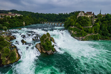 Aerial view of famous Rheinfall and colorful touristic boats in Switzerland