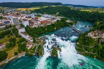 Aerial view of famous Rheinfall and colorful touristic boats in Switzerland