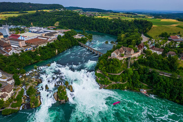 Aerial view of famous Rheinfall and colorful touristic boats in Switzerland