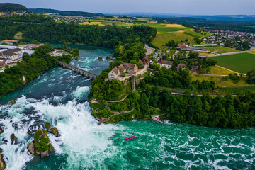 Aerial view of famous Rheinfall and colorful touristic boats in Switzerland