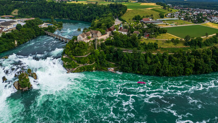 Aerial view of famous Rheinfall and colorful touristic boats in Switzerland