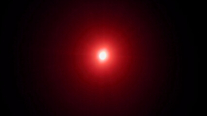 red lens flare Real optical lens flare on black background