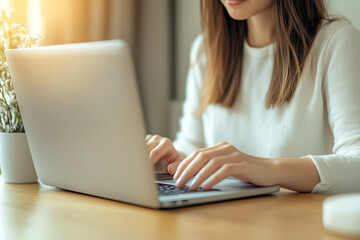 Fototapeta premium Close-up of a businesswoman sitting at the table and working on a laptop