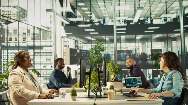 Happy employee starting first day at new job, unpacking belongings, meeting coworkers. Cheerful worker arriving in office, starting work on new company position, being welcomed by team, camera B