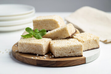 Delicious puffed rice bars and mint on white wooden table, closeup