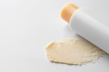 Stick of lip balm and sample on white background, closeup. Space for text