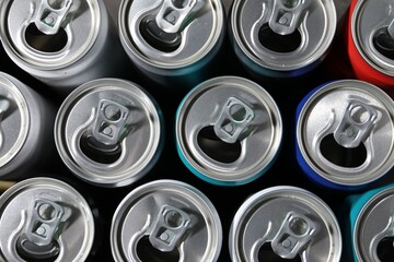 Many aluminium cans of beverage as background, top view