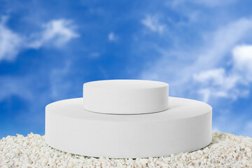 White podium on small stones against blue sky