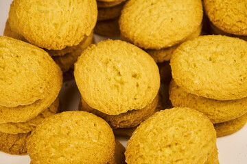 A group of sugar cookies are neatly stacked on top of each other on a white background..Close-up