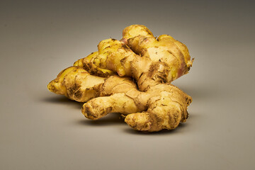 Fresh ginger root with peel isolated on white background with space for text