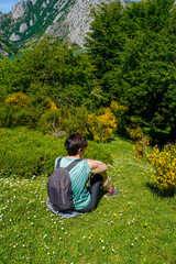 Woman sitting contemplating a beautiful landscape